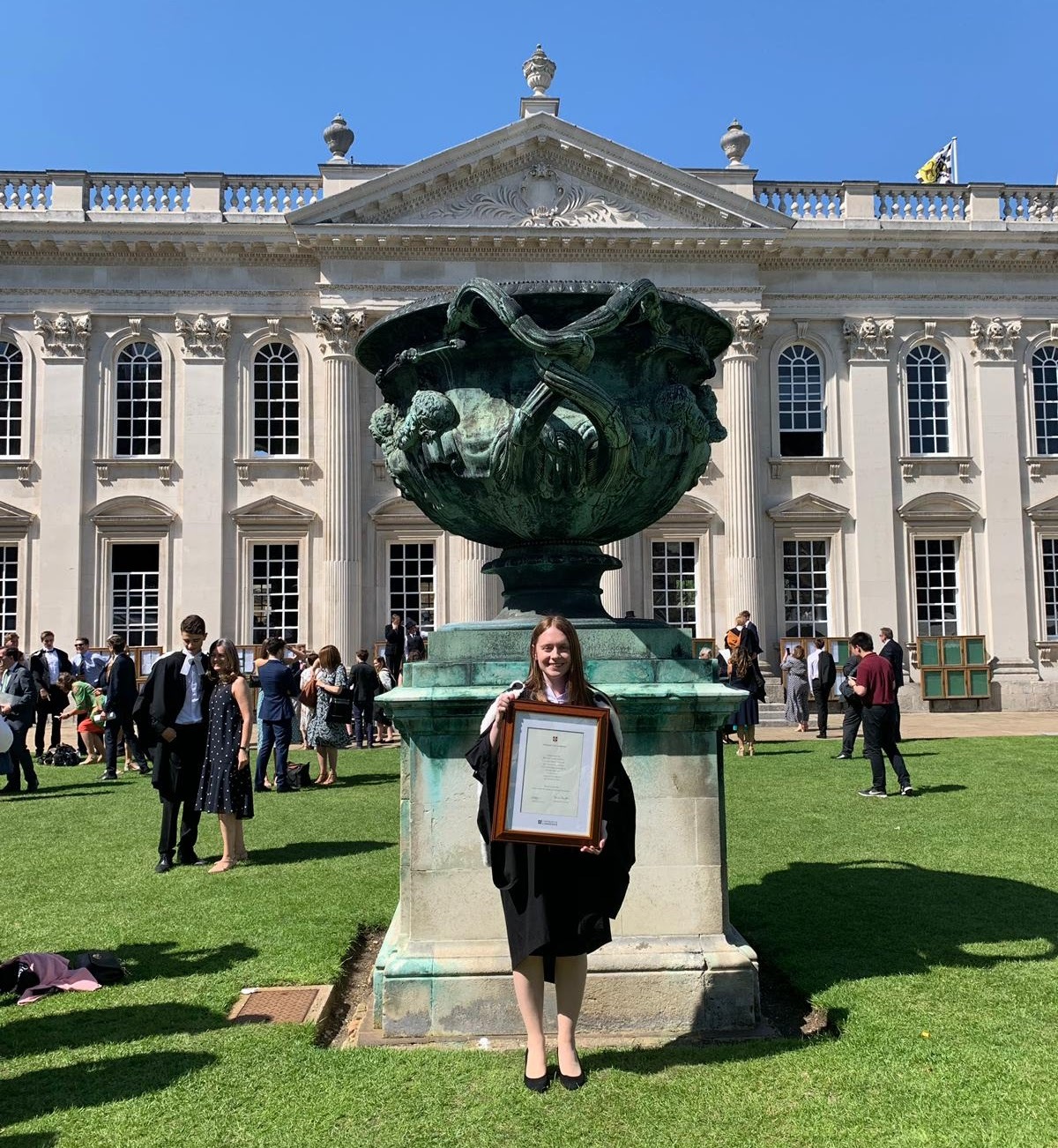 Bethany posing with framed diploma 